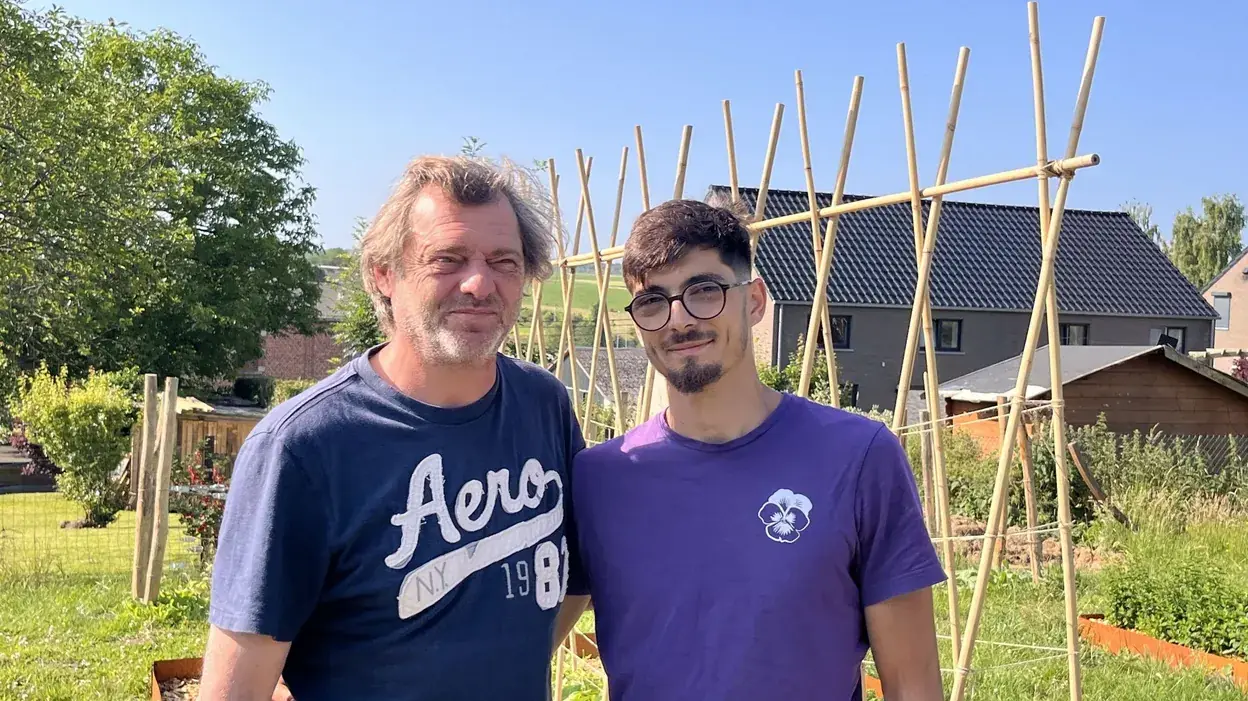 Benoît Blairvacq et son fils Nour, côte à côte dans un jardin comestible, devant des tuteurs en bambou